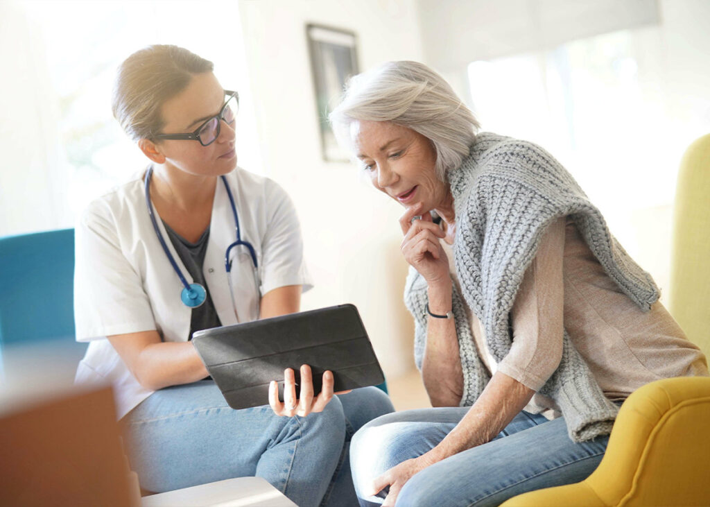 Seated patient reviewing information on a tablet.