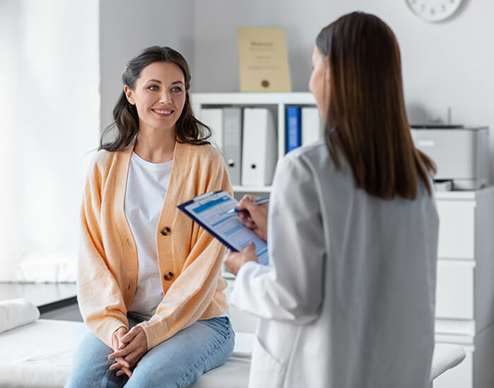 Patient in exam room with healthcare professional.